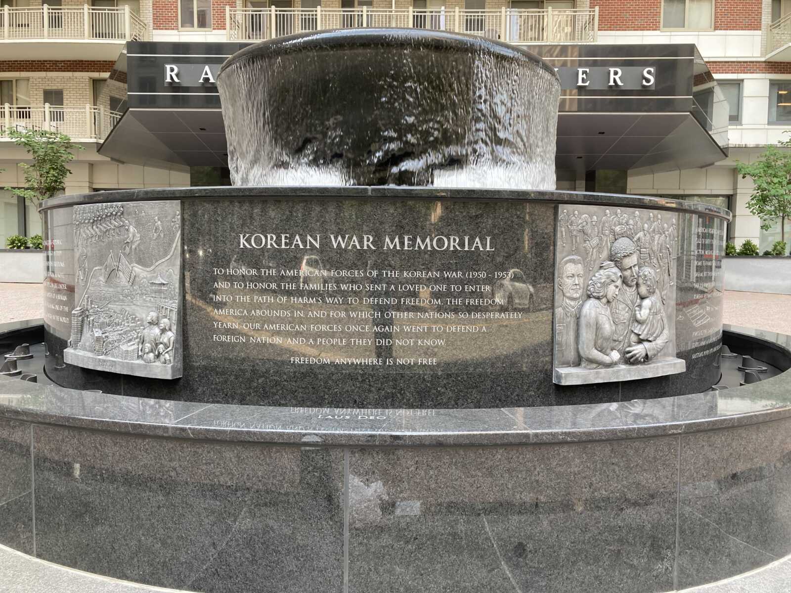 Korean War memorial outside of Randolph Towers in Ballston (courtesy Gale Harris) | ARLnow Circular black granite Korean War Memorial fountain with cascading water and carved relief panels around the base.