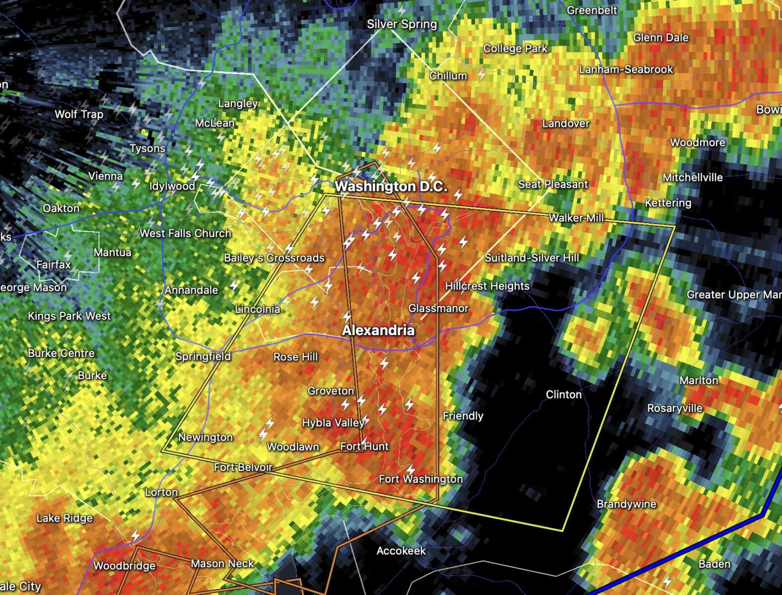 Radar map showing a storm system over Washington, D.C. area with heavy orange/red colors near Alexandria and surrounding suburbs; white lightning bolts indicate lightning activity within the cells.