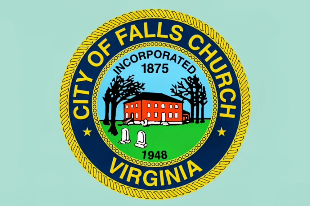 The Falls Church city flag is based on the city seal (via City of Falls Church) | ARLnow Seal of the City of Falls Church, Virginia, showing a red brick building with trees and tombstones on a green lawn, dates 1875 and 1948, surrounded by a gold-bordered blue ring.