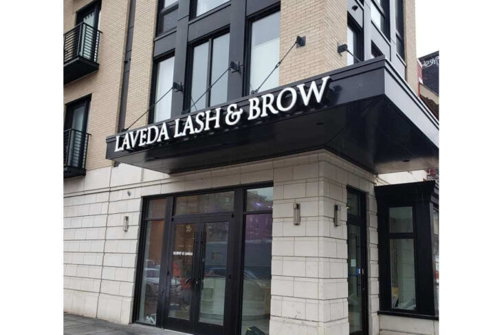 Exterior of Laveda Lash & Brow salon with black storefront and glass doors.