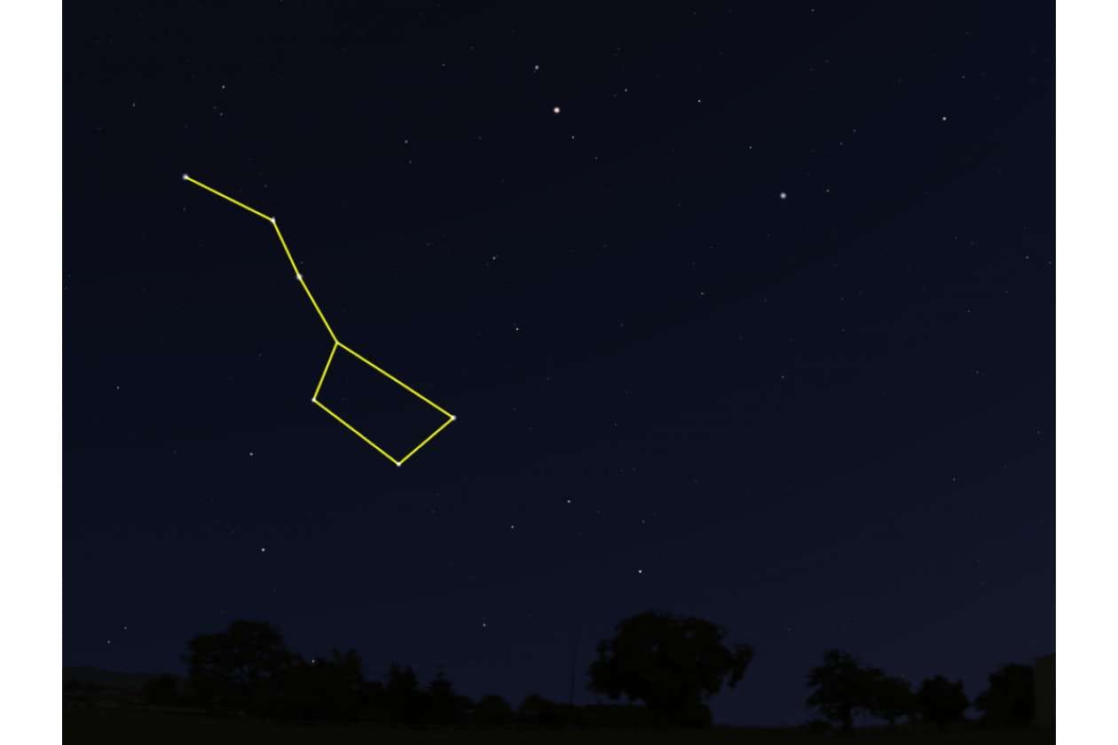 Night sky with a glowing yellow outline tracing a constellation against stars at night.