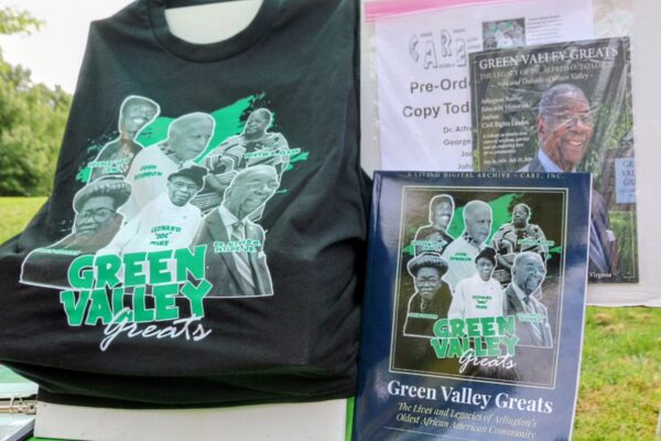 Black T-shirt and posters featuring a collage of Black leaders labeled 'Green Valley Greats'.