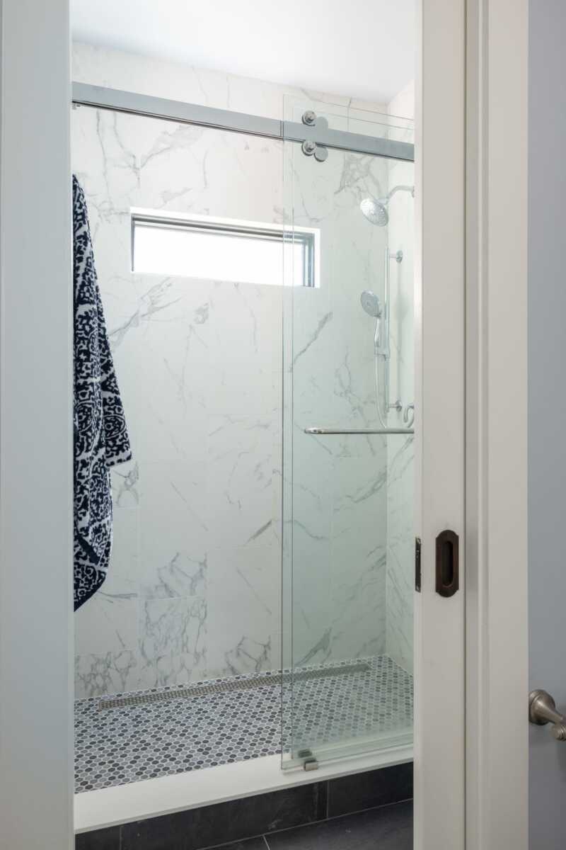 A recent Arlington home addition and remodeling project included a first-floor powder room with a shower hidden behind pocket doors. Perfect for older guests and future aging in place. Photo credit: Christy Kosnic Photography. | ARLnow A recent Arlington home addition and remodeling project included a first-floor powder room with a shower hidden behind pocket doors. Perfect for older guests and future aging in place. Photo credit: Christy Kosnic Photography.