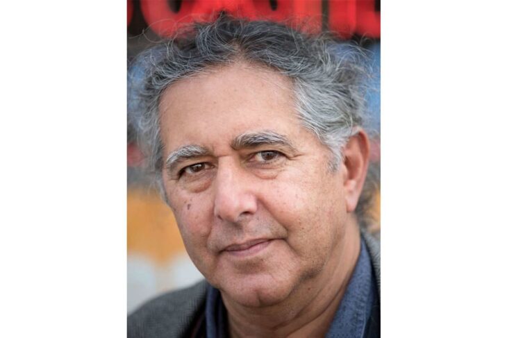 Head-and-shoulders portrait of a middle-aged man with gray hair, looking at the camera.