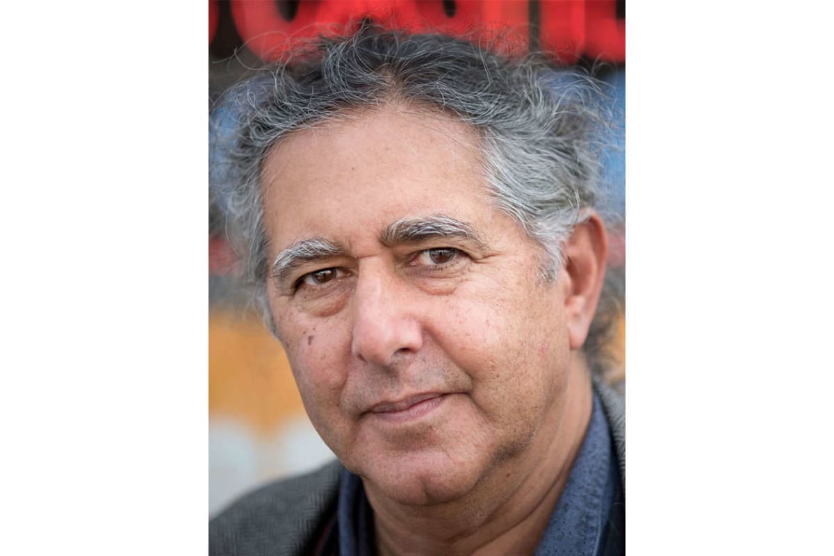 Head-and-shoulders portrait of a middle-aged man with gray hair, looking at the camera.