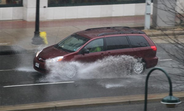 Car drives through standing water in Pentagon City