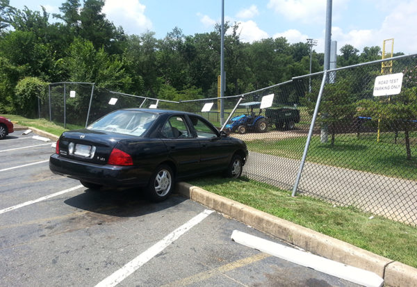 Car crashes into fence at DMV on Four Mile Run Drive (courtesy photo)