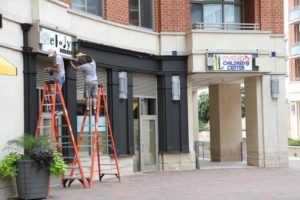 Signs changing from Melody Tavern to Crystal City Children's Center